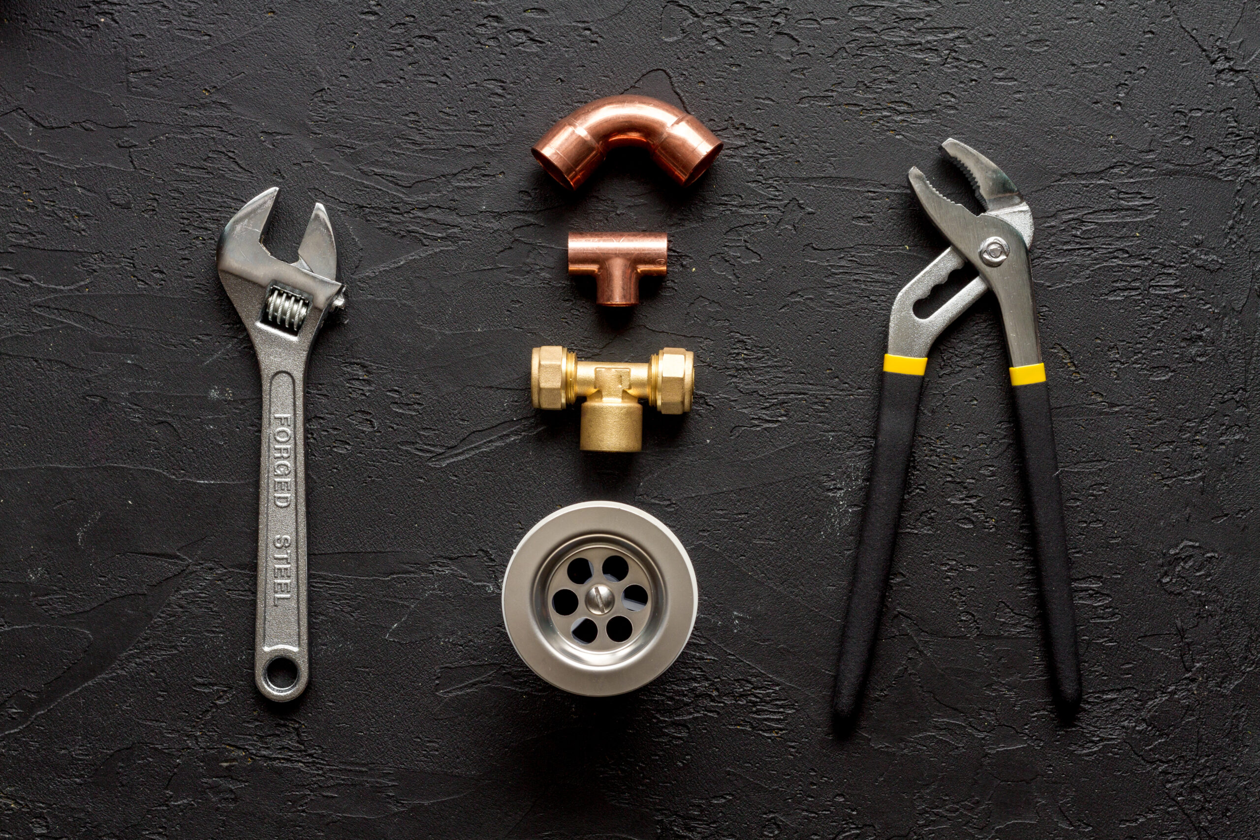 Professional plumber checking a boiler and pipes, boiler service concept.