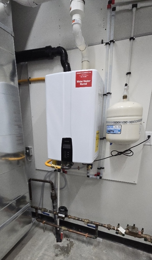 Modern electric boiler on light wall